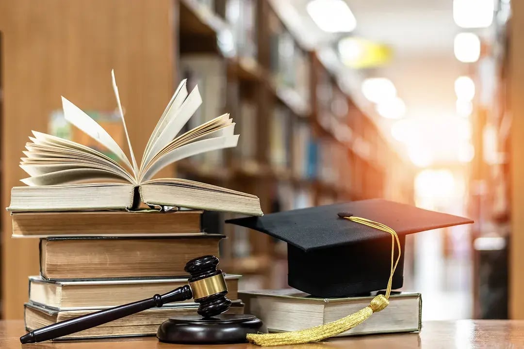 graduation cap and books