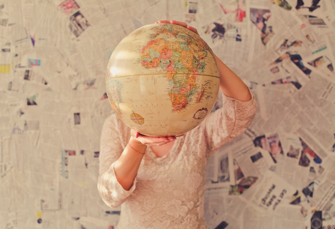 woman holding a globe