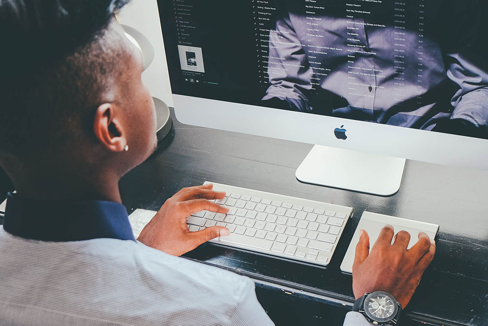 man typing on computer