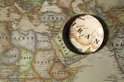 map of the middle east with magnifying glass on Iran 