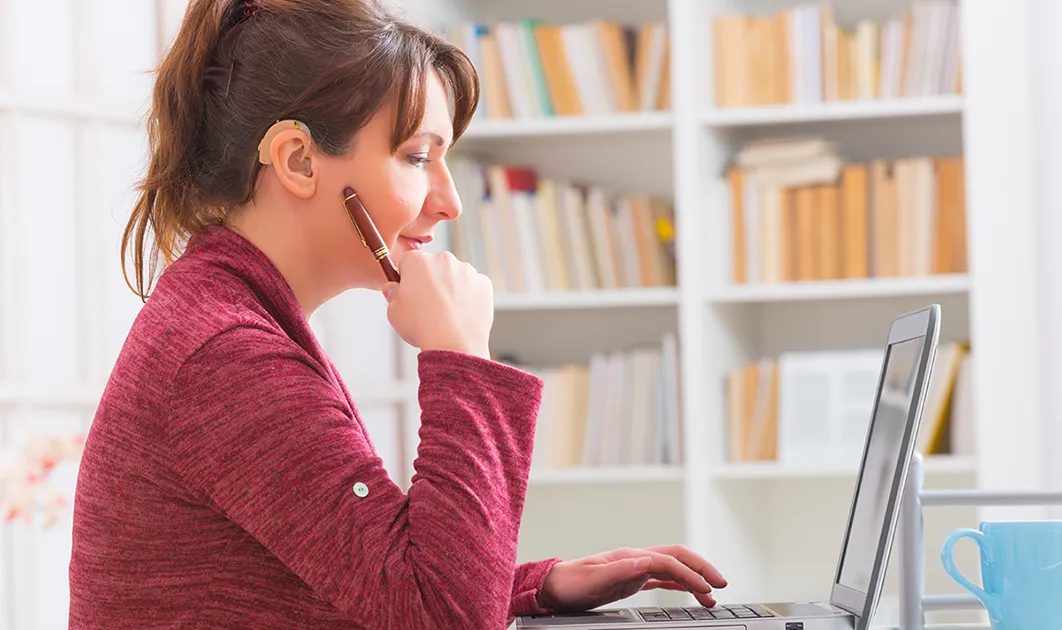 woman with hearing impairment working on computer